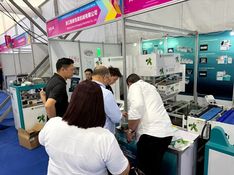 Booth A43-46, staff introducing packaging machinery equipment to customers